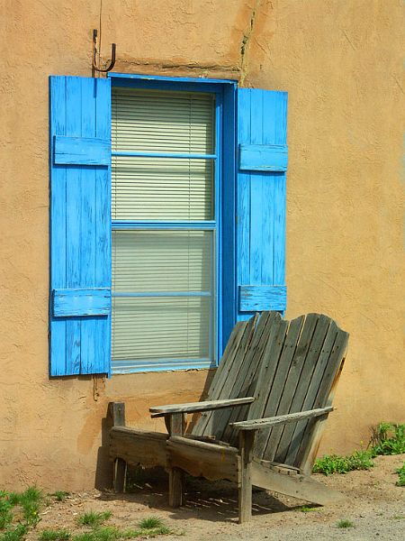BlueShutterschairPICT5057-w.jpg - #0093_Blue Shutters with chairs:  The blue of the shutters is the actual vibrant blue I saw while walking the back streets in Old Mesilla, Las Cruses, New Mexico, Spring 2005.  I liked the blue against the adobe building with the added interest of the twin Adirondack chairs that were showing their age and the intrigue of the closed window blinds.